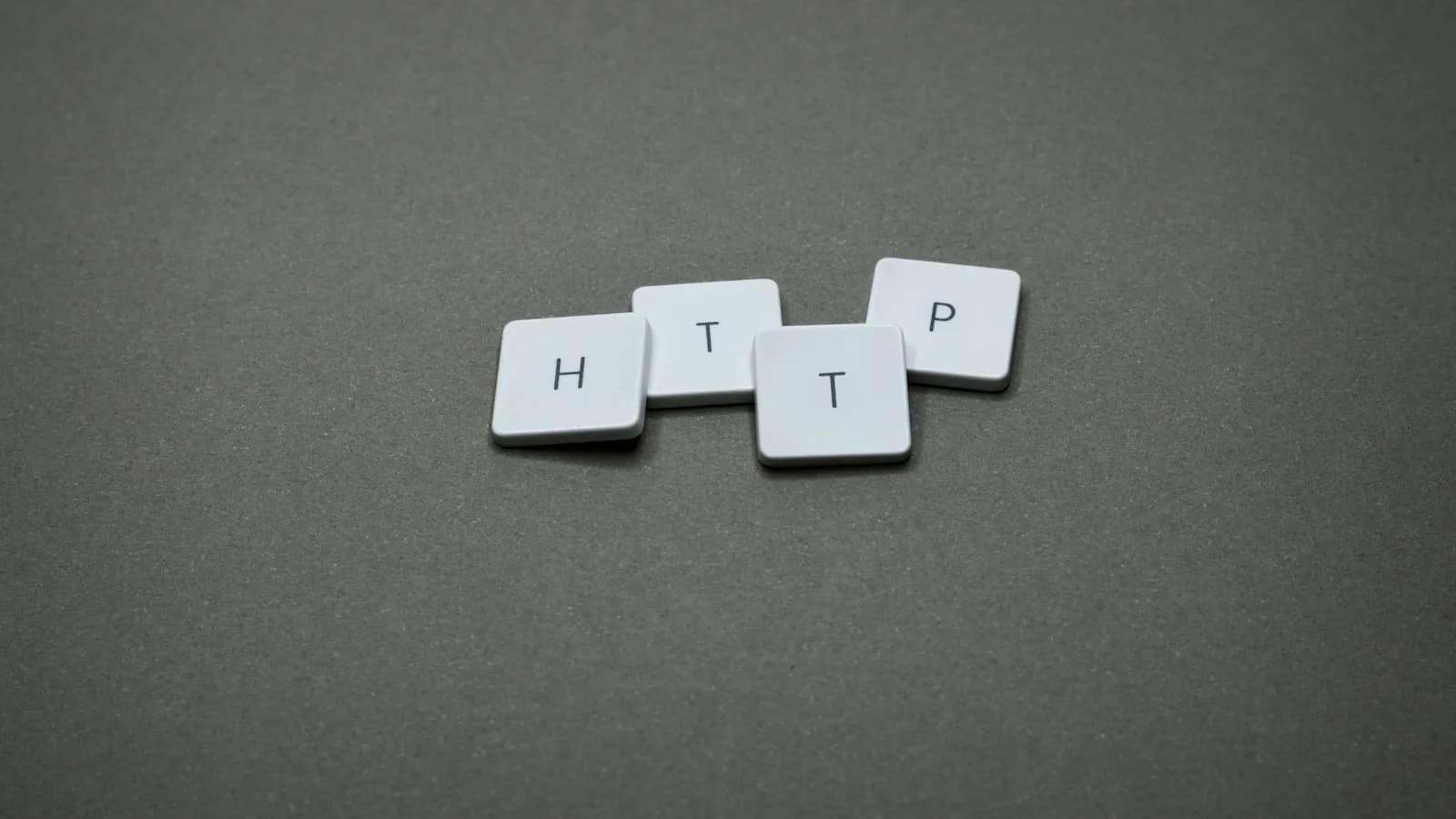 Letter tiles spelling HTTP on a grey background