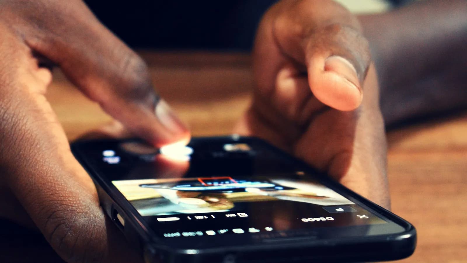 A finger tapping on a smartphone screen